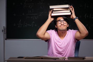 Young male student sitting in classroom