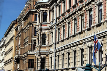 Fototapeta premium Facade of a front of old city houses in helsinki, finland with flag