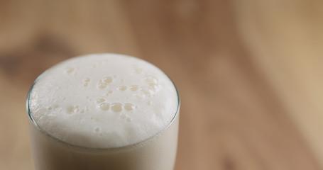 Closeup lager beer in the glass on wood table