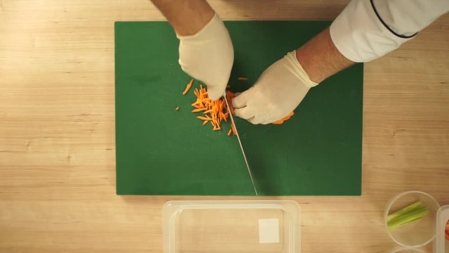 Chef is cooking vitamin salad from fresh vegetables. Time lapse top view