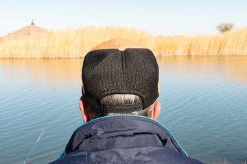The man in the cap in front of a small river