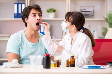 Doctor getting saliva test sample in clinic hospital