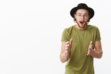You would not believe. Charismatic excited and amazed handsome european male with beard in glasses...