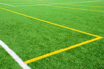 Obraz premium Football field green background with white and yellow line. Sport texture.
