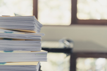 Pile of unfinished documents on office desk, Stack of business paper,Stack of documents placed on a business desk in a business office.
