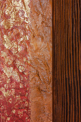 Abstract texture. Tricolor: a red strip with golden spots, an orange strip and a strip of dark brown wood.