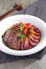 Bacon slice with oil in a white dish