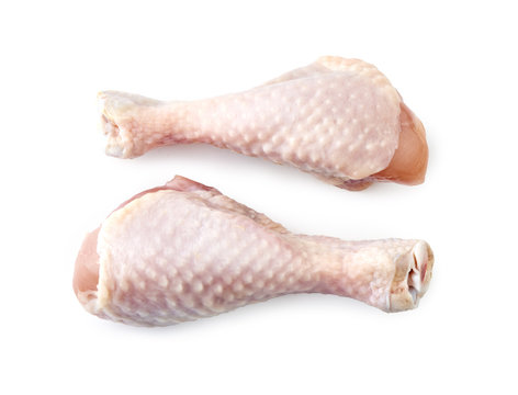Two raw chicken legs isolated on white background. Top view.