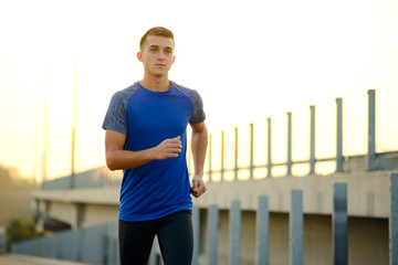 Young Sports Man Running at Sunset. Healthy Lifestyle and Sport Concept.