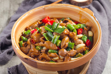 Griddle pork intestines in a ceramic pot