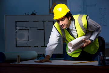 Young construction architect working on project at night 