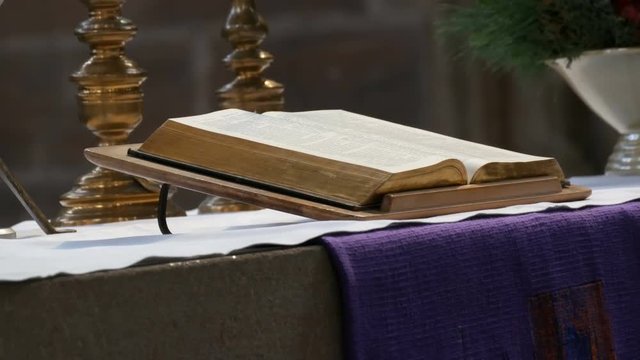 The great book of the priest lies on the altar in the old catholic church