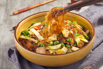 Spicy fried rice noodles with cut bamboo shoots in a ceramic dish