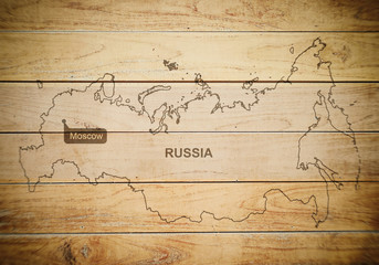 Map of Russia on a wooden background, texture, blurred image