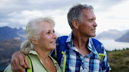 Portrait of loving retired couple trekking The Remarkables