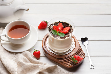 Panna cotta dessert with fresh strawberry on wooden table