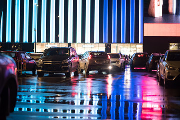 outdoor car parking at night with a lot of light and colors