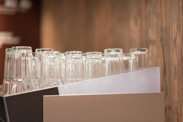 Glasses stand empty upside down. Clean kitchenware for drink. Set of clean glasses in dining room. Clean glasses are dried in restaurant. Dry service