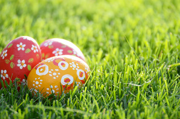 Fototapeta na wymiar Handmade Painted Easter eggs on green spring grass. Space for text