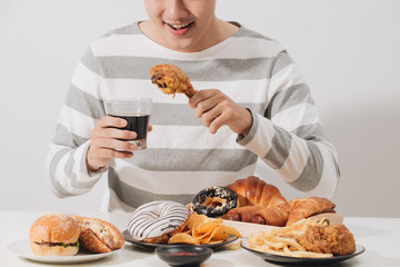 People eating fast food concept hand holding deep fried chicken carbonated soft drink