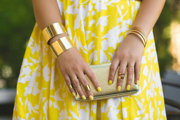 Unrecognizable woman holding wallet in her hands. Lady`s hands wearing rings and accessiories. Girl...