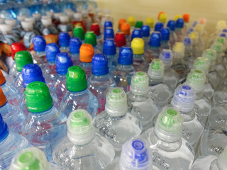 Plastic water bottles with caps of different colour