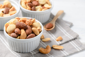 salted cocktail nuts on white wood