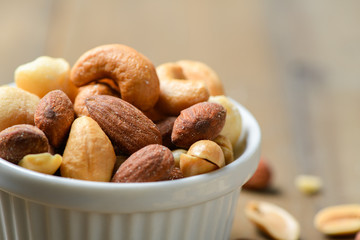Closed up of salted cocktail nuts in cup