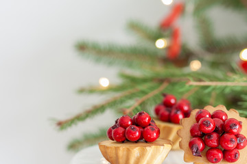 Obraz na płótnie Canvas delicious christmas cupcake with glazed red berries 
