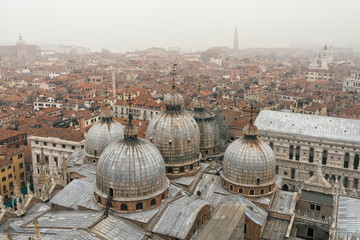 Fototapeta na wymiar Top view on tile roofs in foggy morning in Venice, Italy