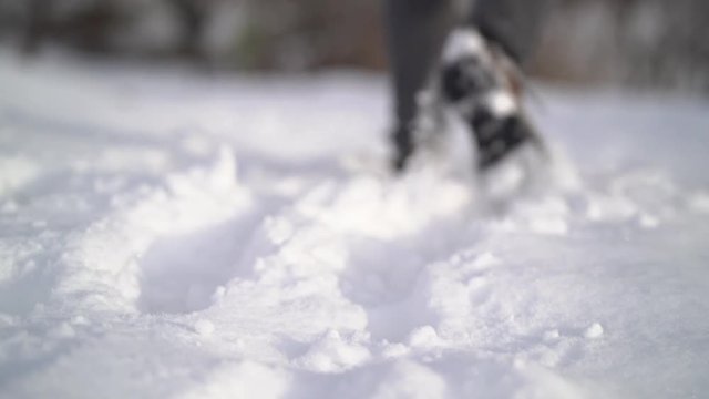 Slow motion video. foot feet steeps. hiking walking. slow motion. snow winter landscape. recreation activity. holiday vacation tourism. people persons. outdoors sports