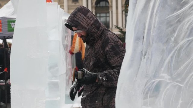The sculptor creates an ice sculpture