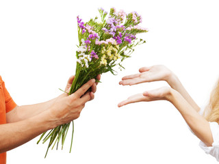 Fototapeta na wymiar The man gives bouquet of wildflowers to his girlfriend. bouquet of wildflowers in hands