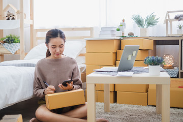 Young asian woman seller talking phone with customer for online business, online shopping,...
