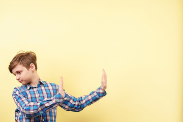 no, thank you. rejection, discard, refusal, boy turning down with rejecting gesture over yellow...