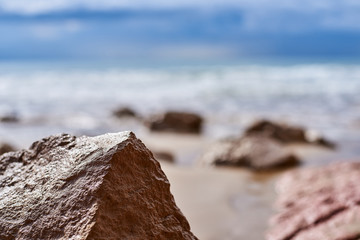 beautiful landscape, stones close up, sandy beach,  sea