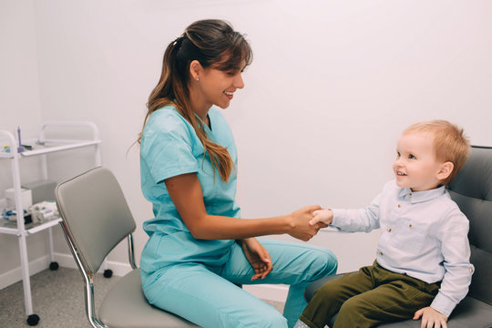 Handshake with little patient, at medical office. Consultation and reception of the children's audiologist