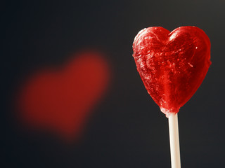 Obraz premium Candy red heart rotating on black