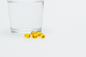Vitamins, drugs, pills, medicine, glass of water Isolated on white background