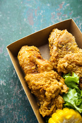 Fried chicken on wooden background.