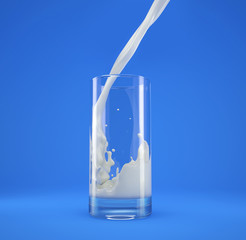 Glass of fresh milk with pouring and splash. On blue.