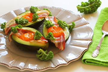 Breakfast. Avocado Egg Boats with crunchy bacon, kale cabbage