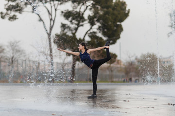 Young girl does yoga at the park