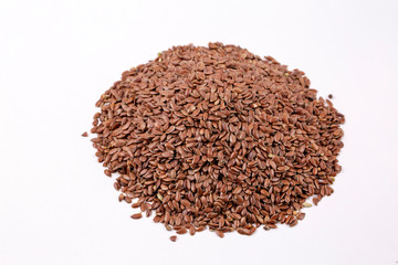 Pile of flax seeds isolated on white background close