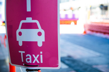 Taxi pick-up point sign in pink color.