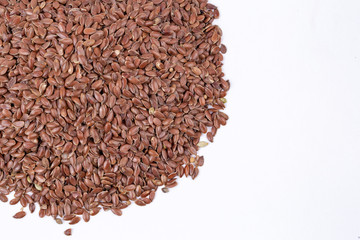 Pile of flax seeds isolated on white background close