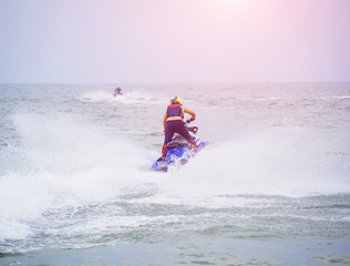 Young guy riding on the jet ski in gulf of Siam