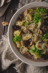 Homemade tortellini with mushrooms and walnuts