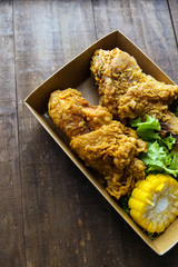 Fried chicken on wooden background.