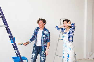 Conflict, redecoration and renovation concept - Young woman and man with annoying faces and bad...